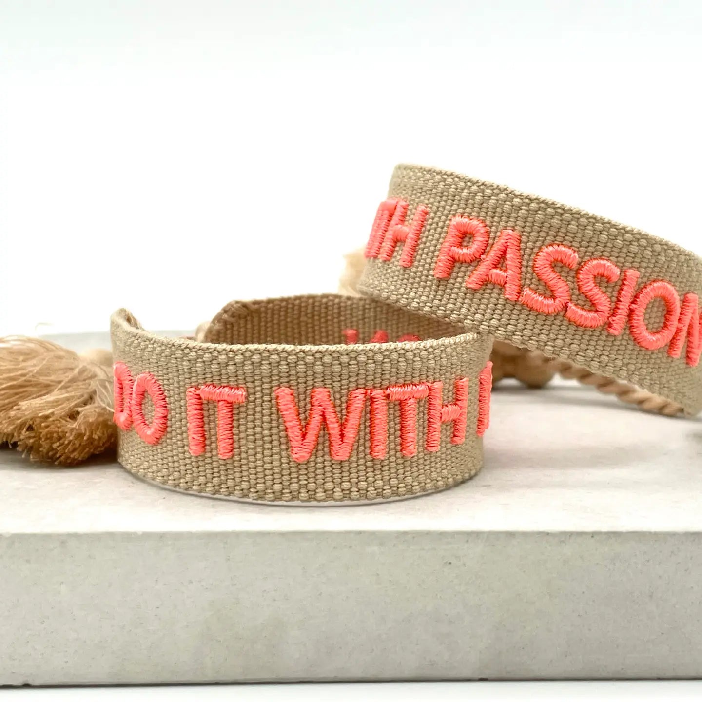 Vävt tygarmband med texten "DO IT WITH PASSION"