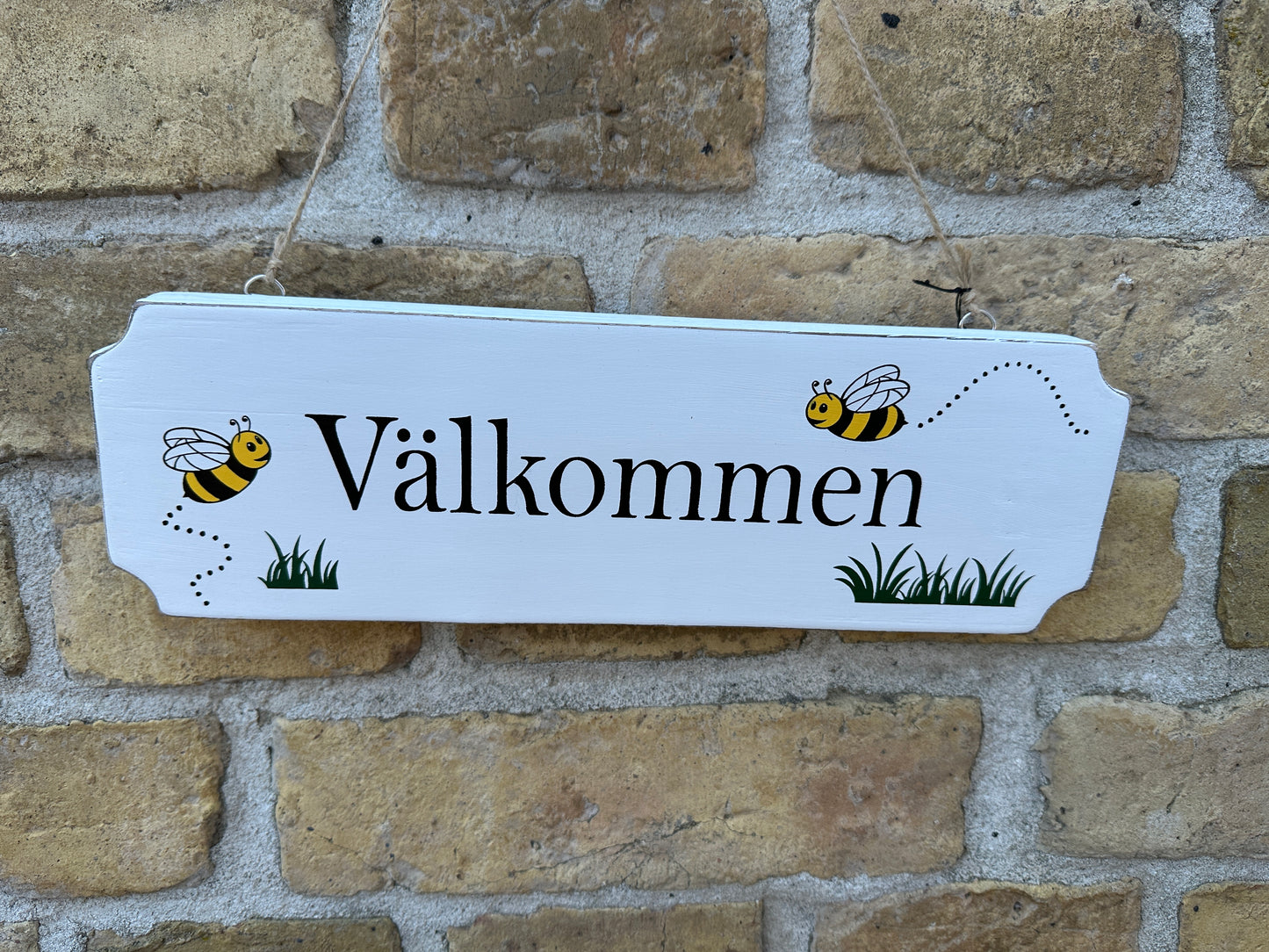 Skylt "Välkommen"