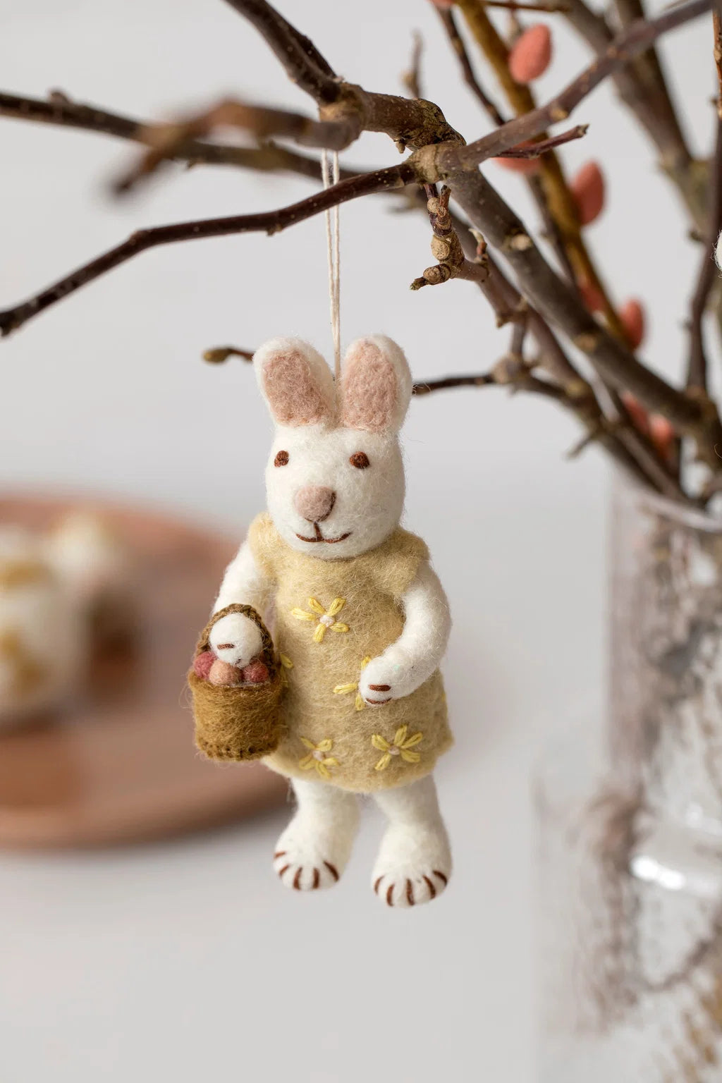 Felted white rabbit with red dress and Easter eggs